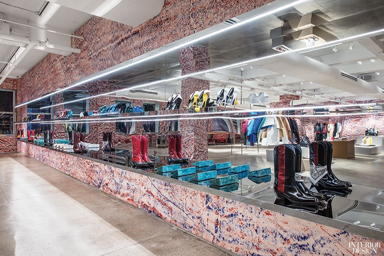 A Calvin Klein showroom with a mirrored wall with boot displays