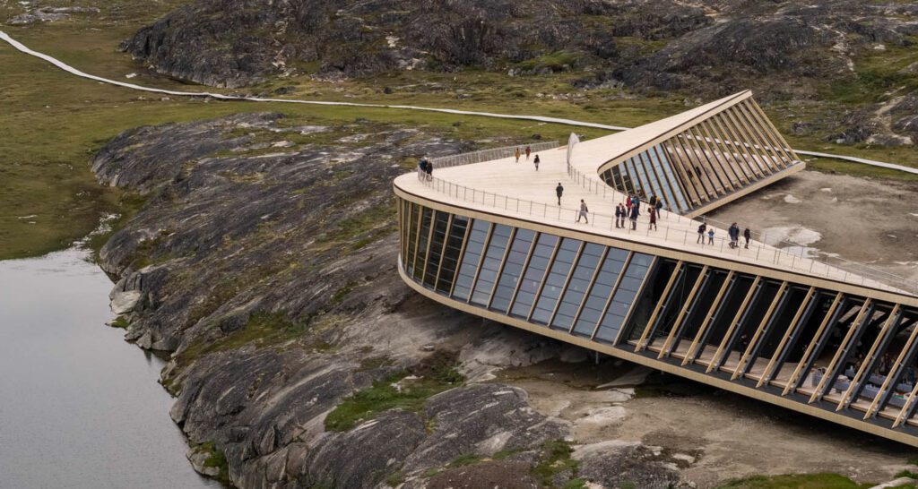 A cultural center on the edge of a cliff overlooking a lake