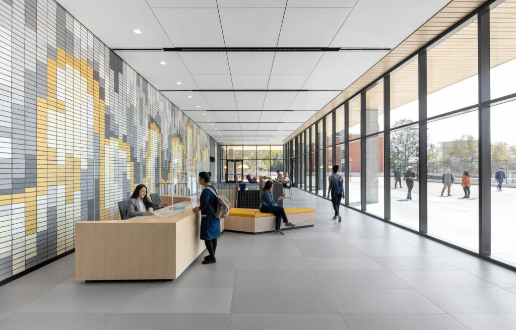 A reception area with a glass wall overlooking a patio 