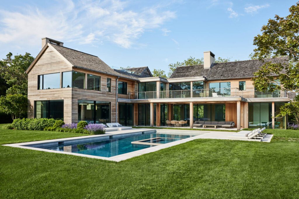 A hamptons home with a large pool in the backyard