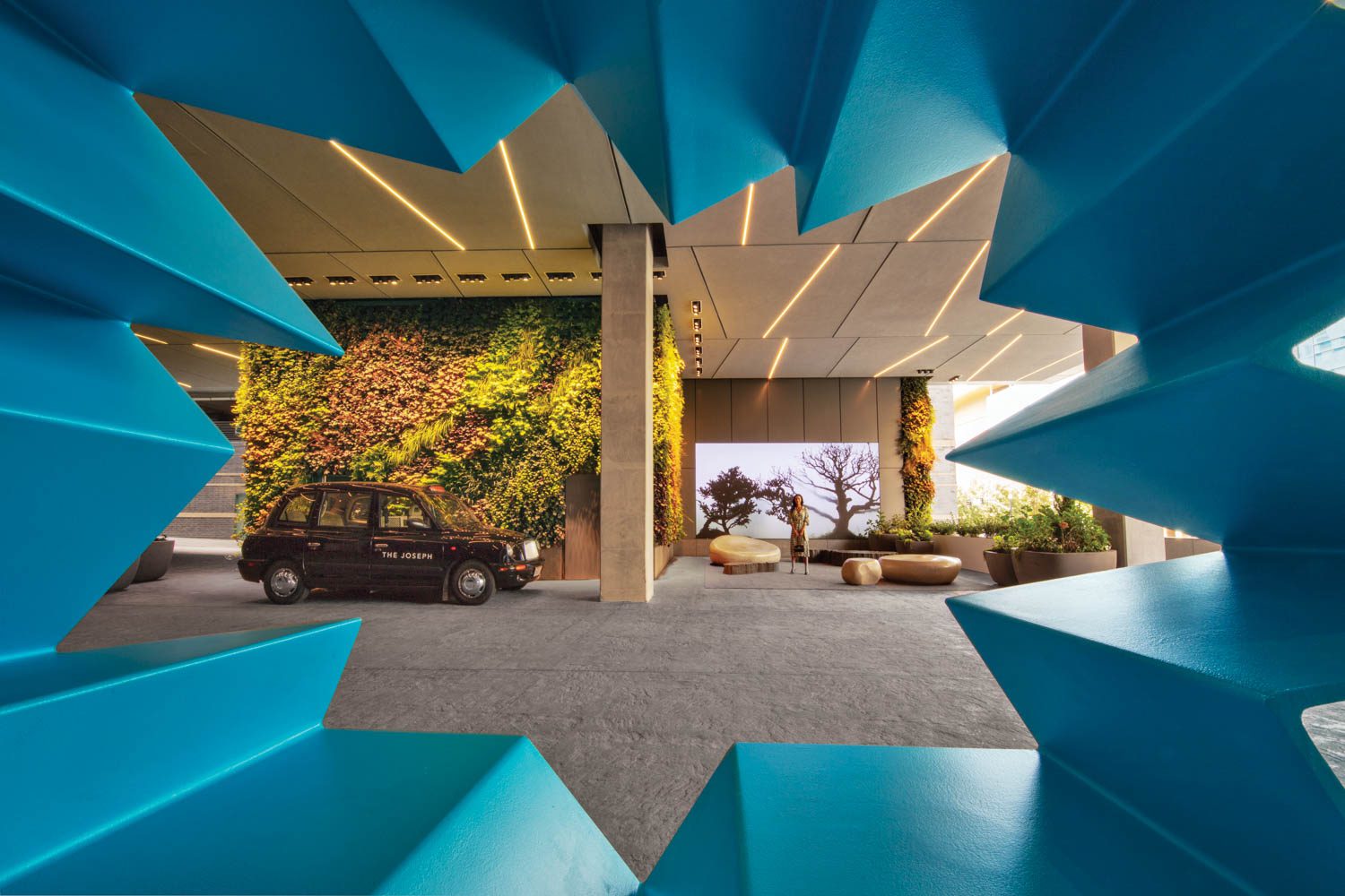 A view through a rolled-steel sculpture by Hank Willis Thomas reveals the porte-cochere entrance to the Joseph, a Luxury Collection Hotel, Nashville, by INC Architecture and Design. Photography by Eric Laignel.