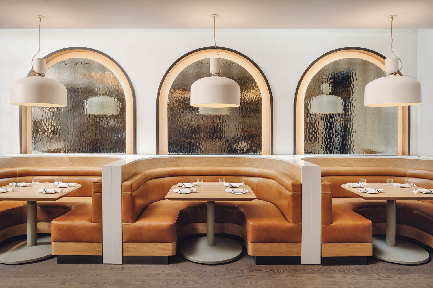 Curved leather booths in Nearly Ninth by Meyer Davis