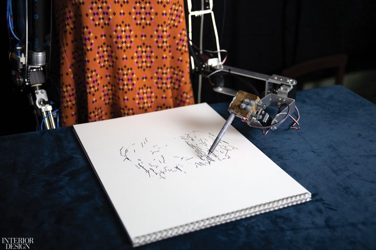 A robot sketches on a white pad at the Design Museum in London