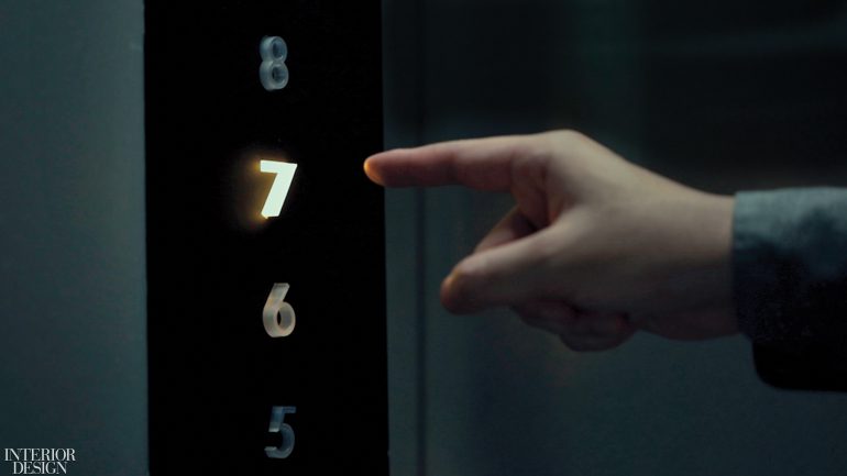 a finger pointing at the glowing number 7 in an elevator