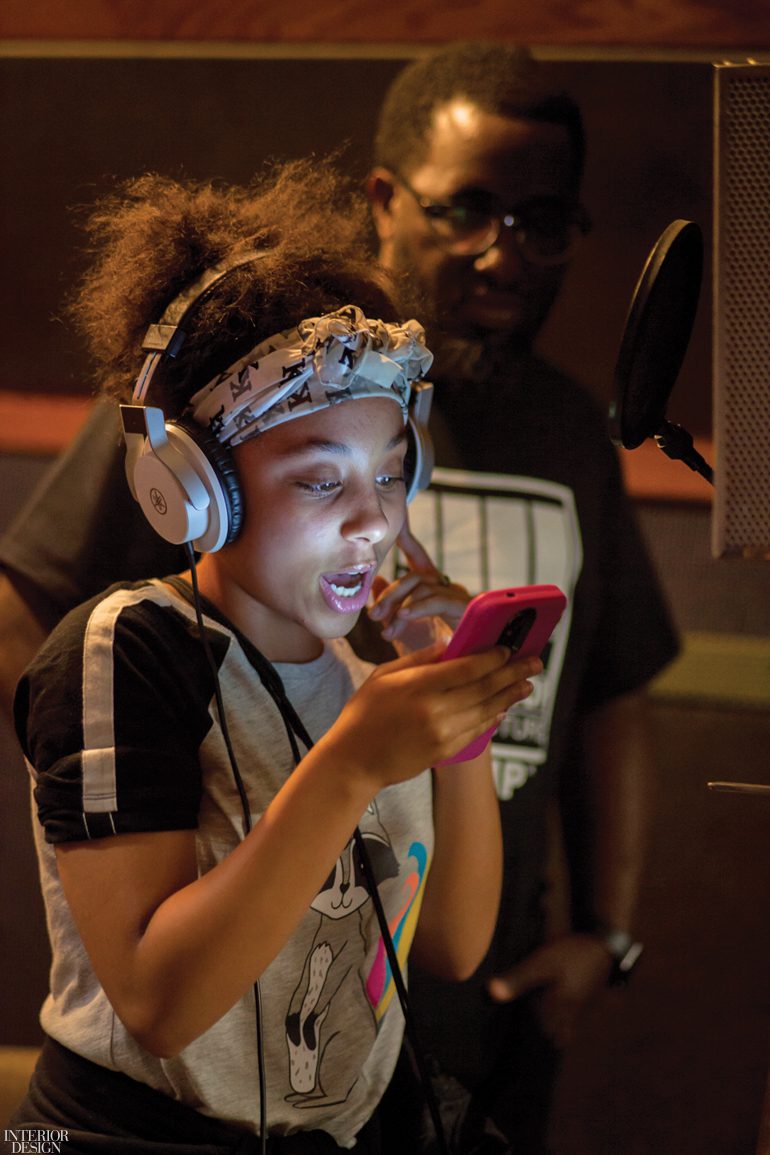 A young student wearing headphones at the Hip Hop Architecture Camp