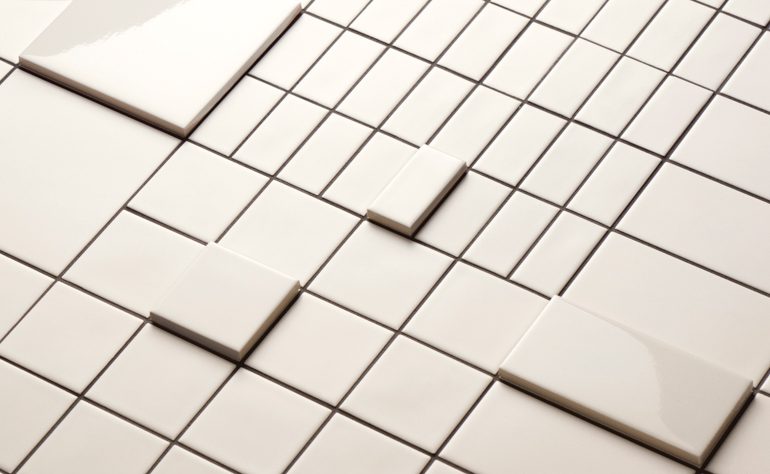 Cream Din Tiles for Mutina in different sizes and shapes fit together to form a grid pattern