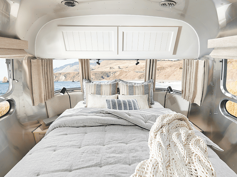 The bed in the airstream travel trailer offers expansive views