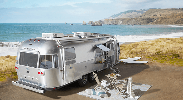 An airstream travel trailer by the ocean