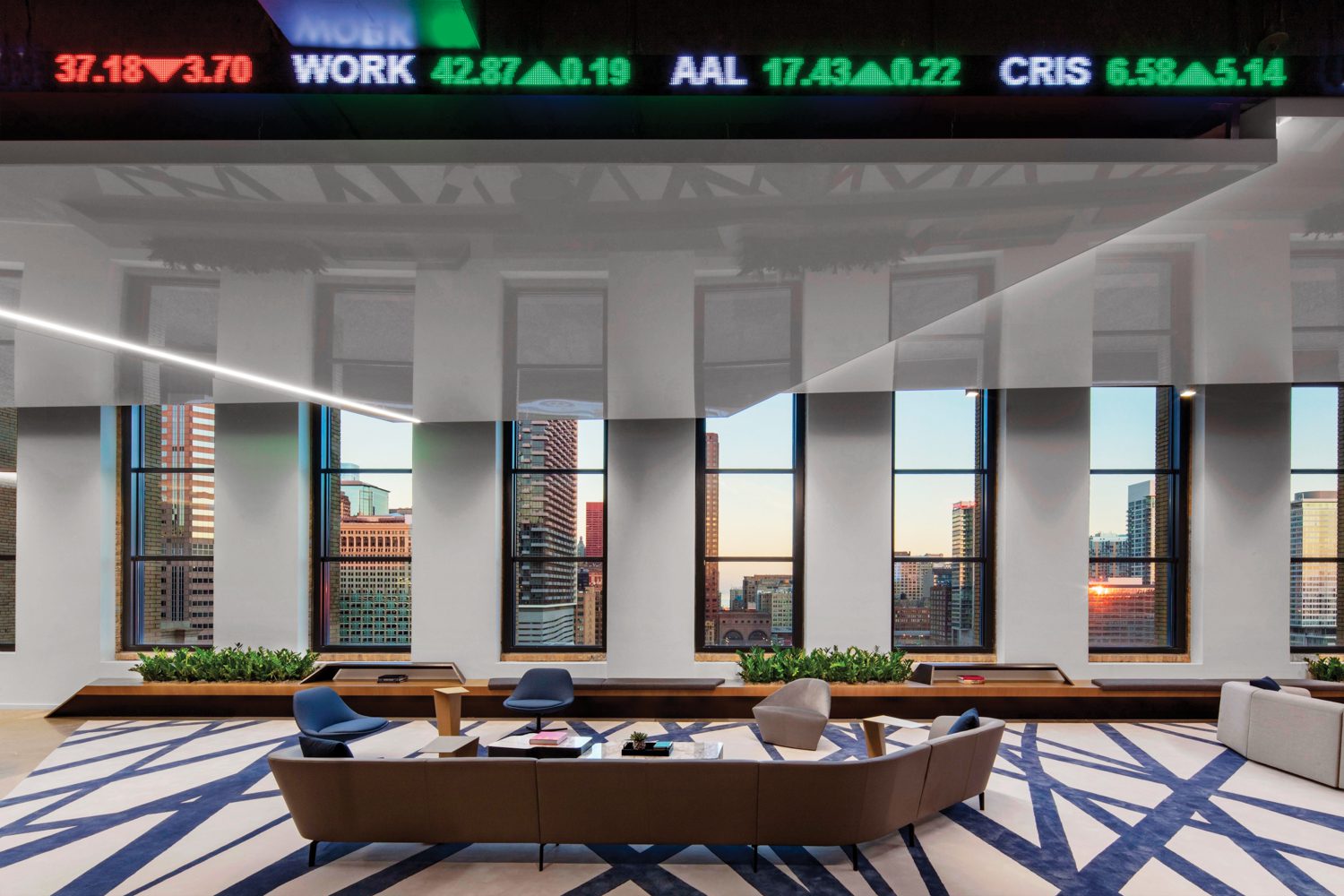 In reception at the Cboe Global Markets headquarters in Chicago by CannonDesign, Lievore Altherr Molina’s Loop sofa and Kelly Wearstler’s Channels rug introduce the angular concept carried throughout the three-floor office.