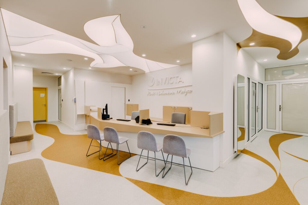 The reception and waiting area at Invicta, a women’s fertility specialist and health clinic in Wrocław, Poland, introduces the design’s emphasis on curves.