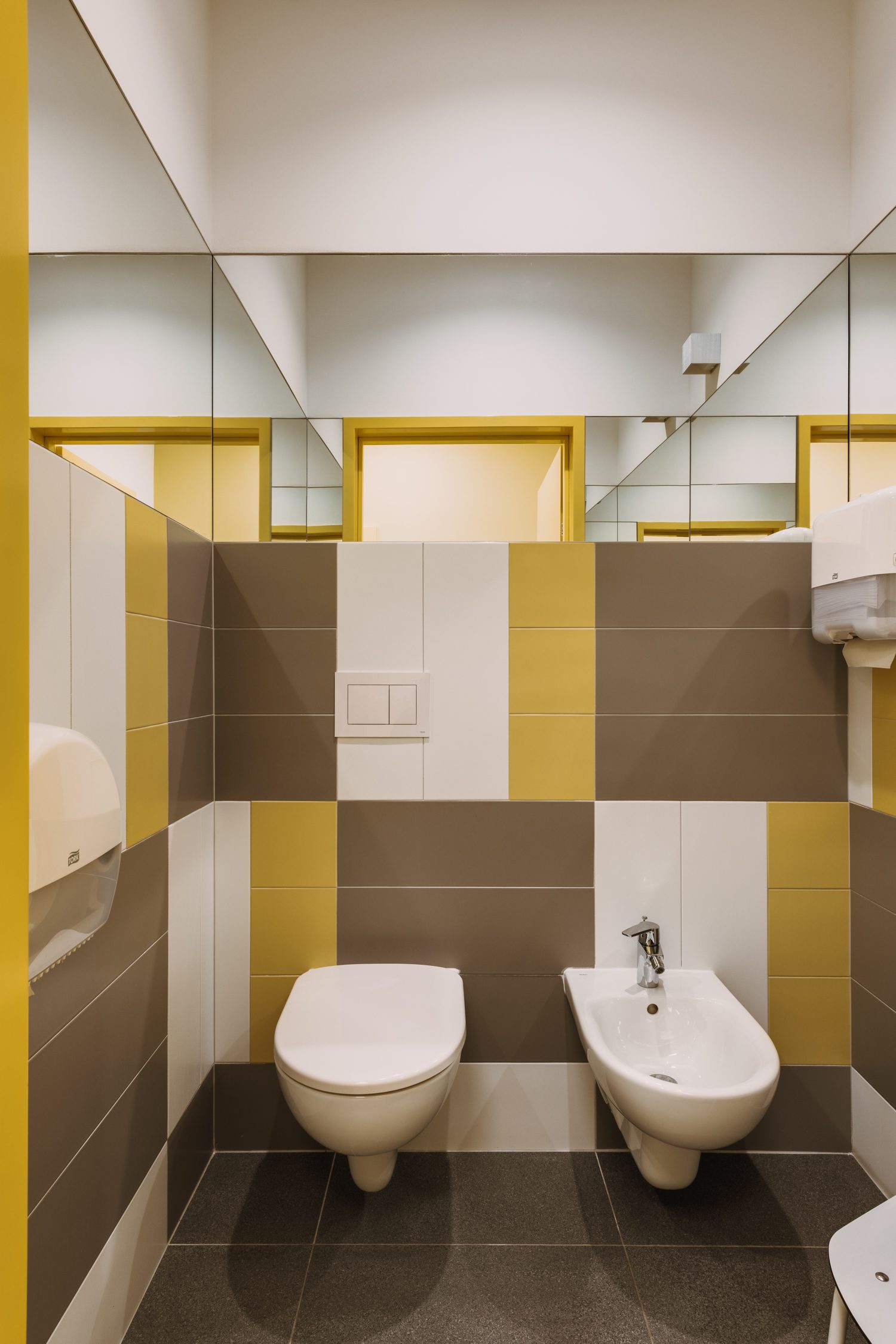 Wall and floor tiles in the bathrooms reiterate the gold-tone color palette.