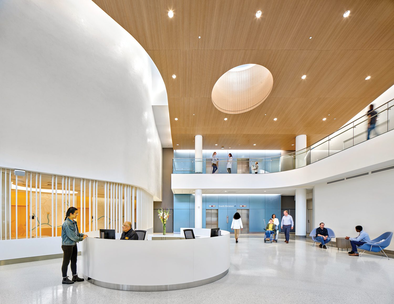 Reception area with a curved white desk and ceiling dotted with small lights.