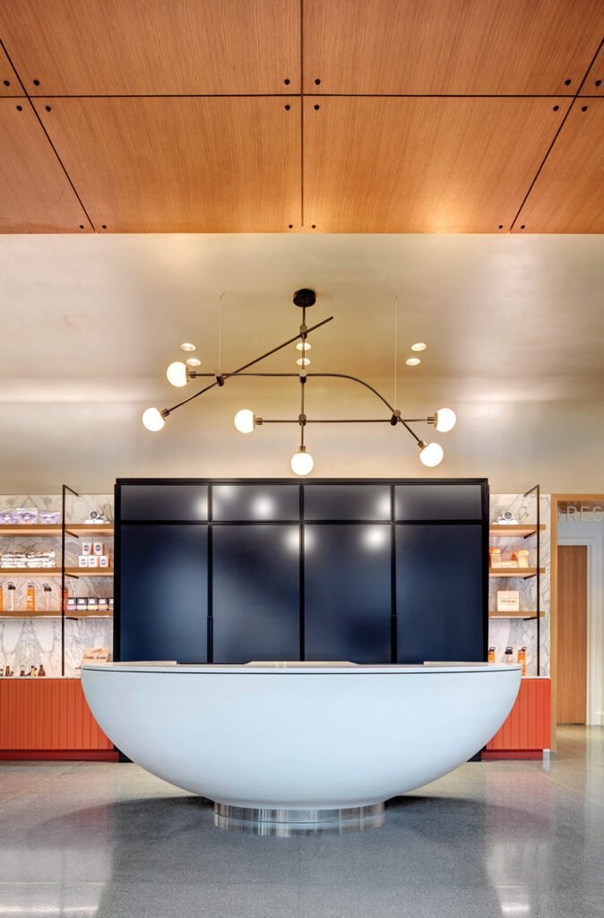 A modern light fixture illuminates a sitting area.