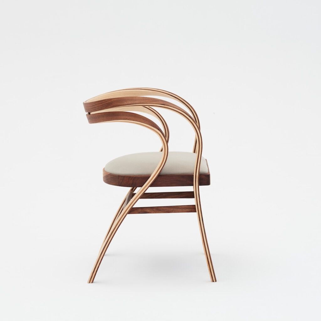 Sinuous handcrafted chair with an airy frame.