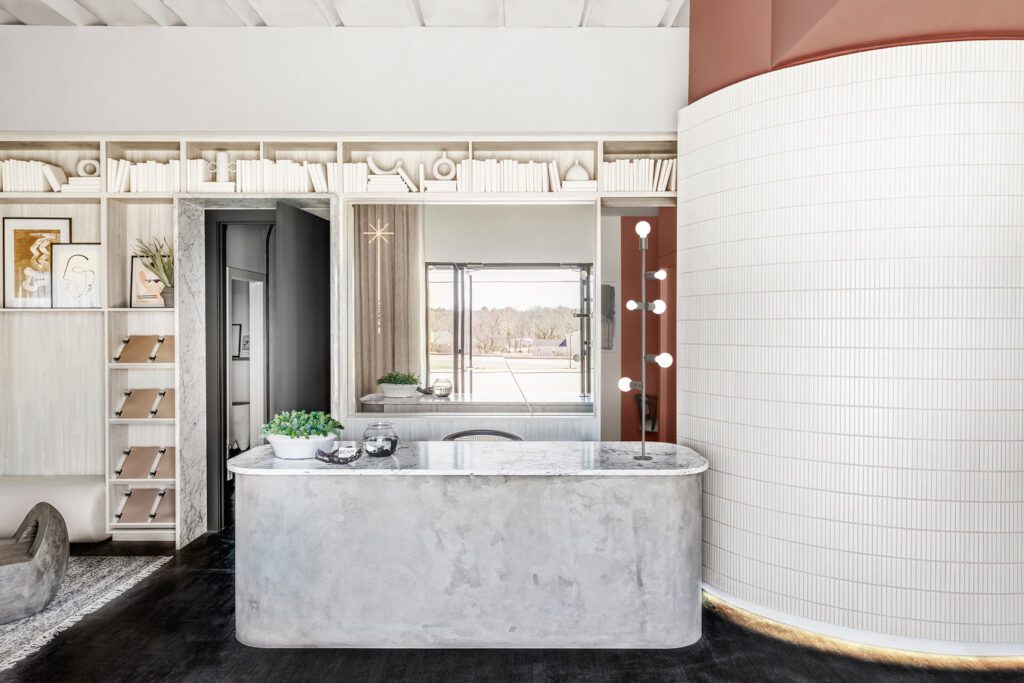 A reception desk topped in Carrara marble—and doorways lined in it—greet guests.