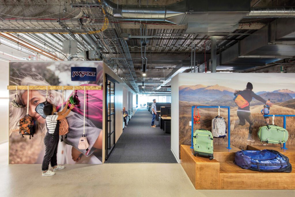 In the JanSport office, printed vinyl wallcovering depicts brand marketing images.