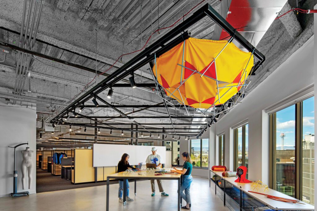 Sealed concrete flooring runs be­neath a tent by The North Face in one of the brand’s work areas called the tinker zone.