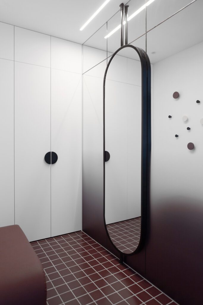 Like the floor-to-ceiling doors, this vertical mirror draws the eye upward, creating the illusion of height..