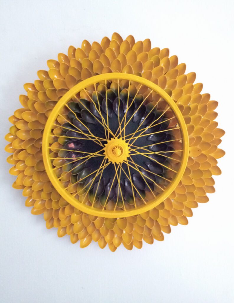 Lagos-based Tomide’s Atelier make pieces out of found objects. This sunflower table/object is made out of plastic spoons and a bicycle wheel.