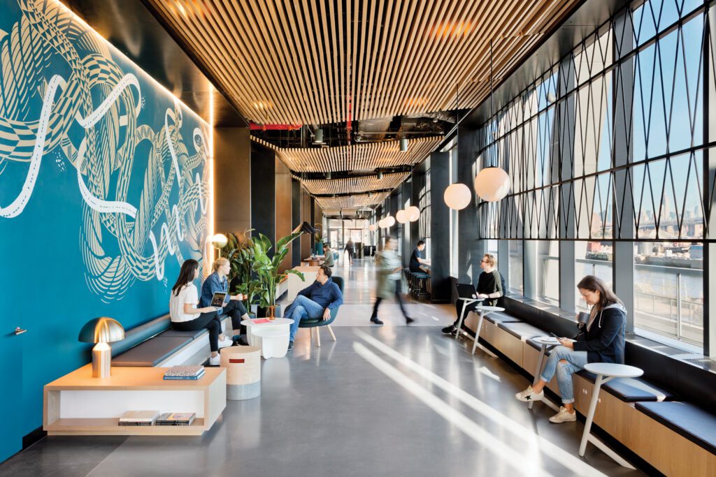 Capped by a wood-slat drop ceiling, the 170-foot-long, terrazzo-floored lobby corridor, with a Dan Funderburgh mural and custom benches, doubles as a lounge.