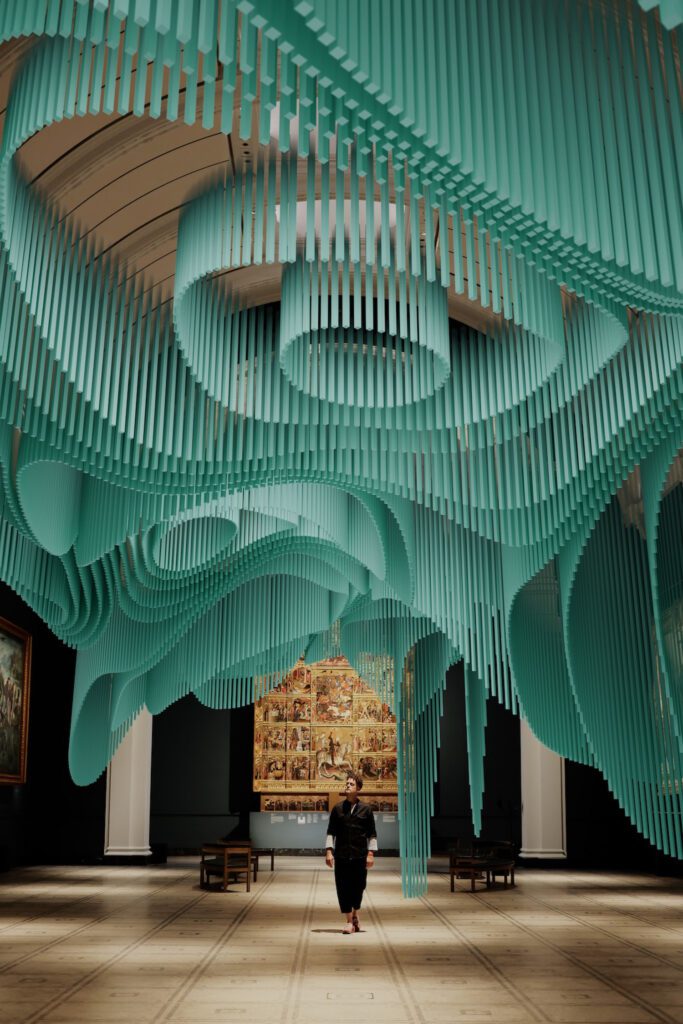 A digital visualization of teal forms hanging from the ceiling.