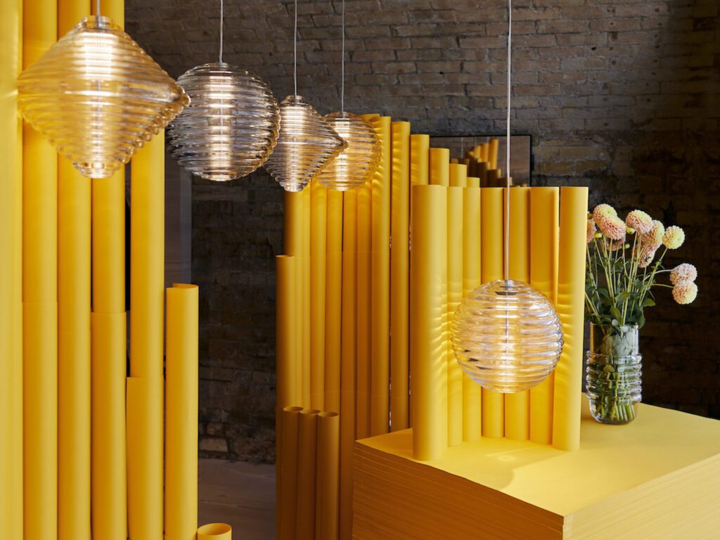 Thick ribbed glass embodies the geometric shapes of the Press light by Tom Dixon.