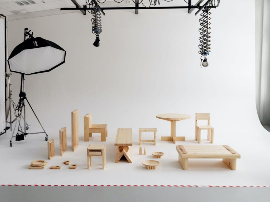 A 12 piece collection of wood furnishings against a photography drop cloth. 