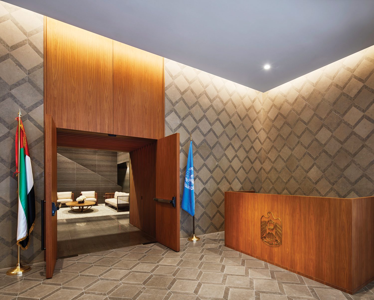 Portuguese limestone tiles clad the floor and walls of the vestibule, where custom wood­work is walnut.