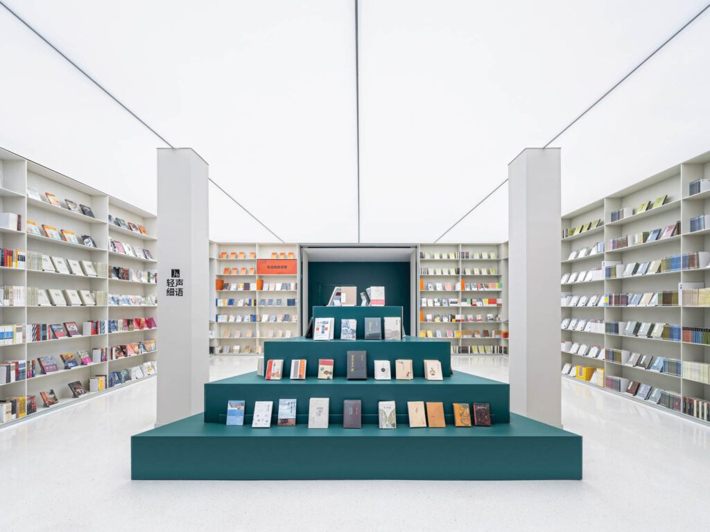 Painted steel forms a ziggurat-style display underneath a ceiling of translucent acrylic panels.