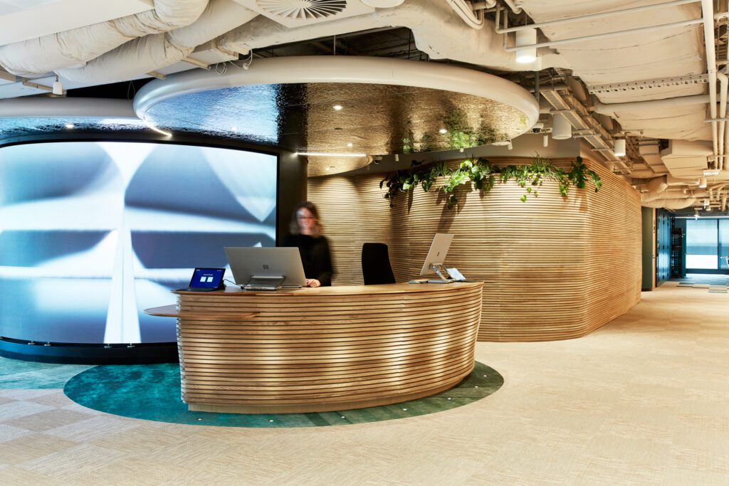 At reception on level 28, customers encounter a custom desk of veneer slats which also form nearby walls.