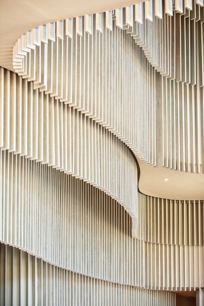 White-oak veneered slats in the hotel's lobby evoke movement.