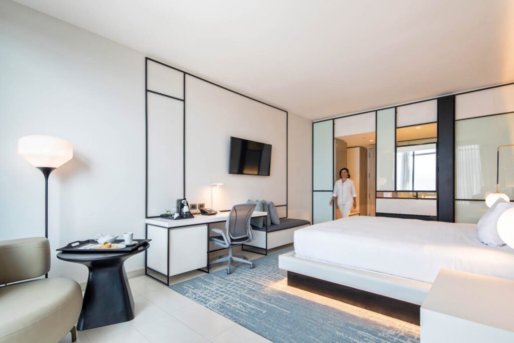 Guest rooms are light-filled spaces that match the overall airy aesthetic of the hotel.