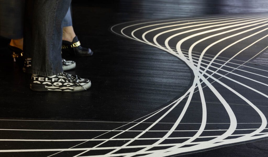 Floor markings mimicked a bike path in a nod to Cunningham’s characteristic mode of transportation, a Biria bicycle.