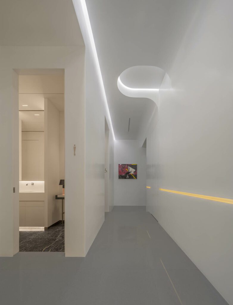 Bathrooms appear like secondary galleries off the art-filled passageways.