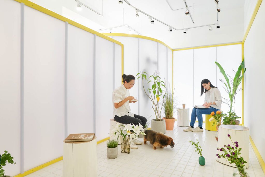 Wood stools painted yellow and white form seating.