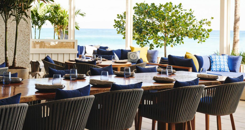 Beachside dining has glass doors opening to its outdoor cocktail terrace. 