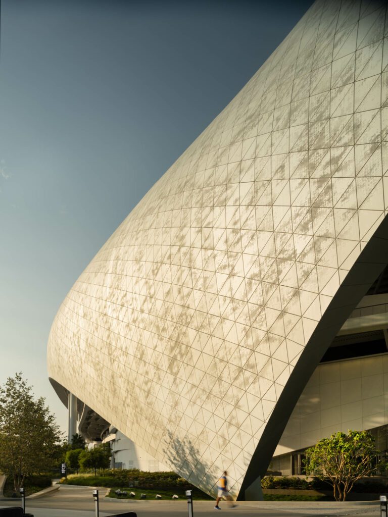 The stadium's roof is made of ETFE, a lightweight translucent plastic formed in triangular panels over a perforated aluminum shell. Photography by Nic Lehoux.