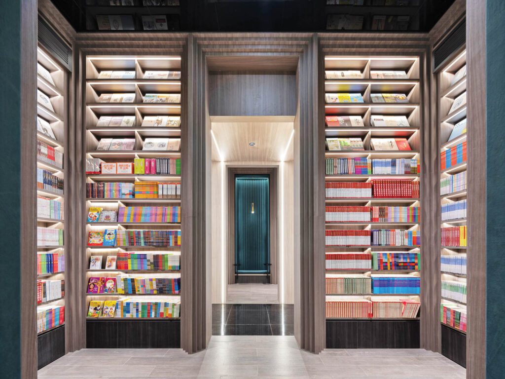 Books are displayed more trad­itionally in the forum, where 14-foot-high stacks are lit by LED strips.