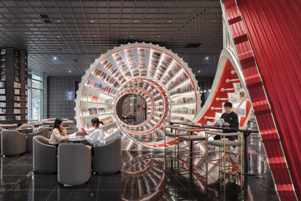 The spiral incorporates the bookstore’s café, with leather-upholstered club chairs, stools, and a powder-coated high table, all custom.