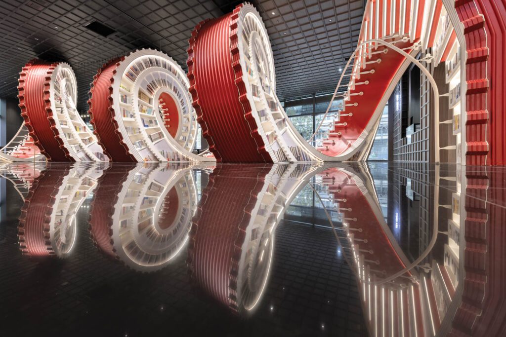 The color of the back of the spiral was chosen because it’s the one with the longest wavelength in the visible spectrum of light, amplified even further by its reflection cast in the floor of mirror-polished terrazzo.