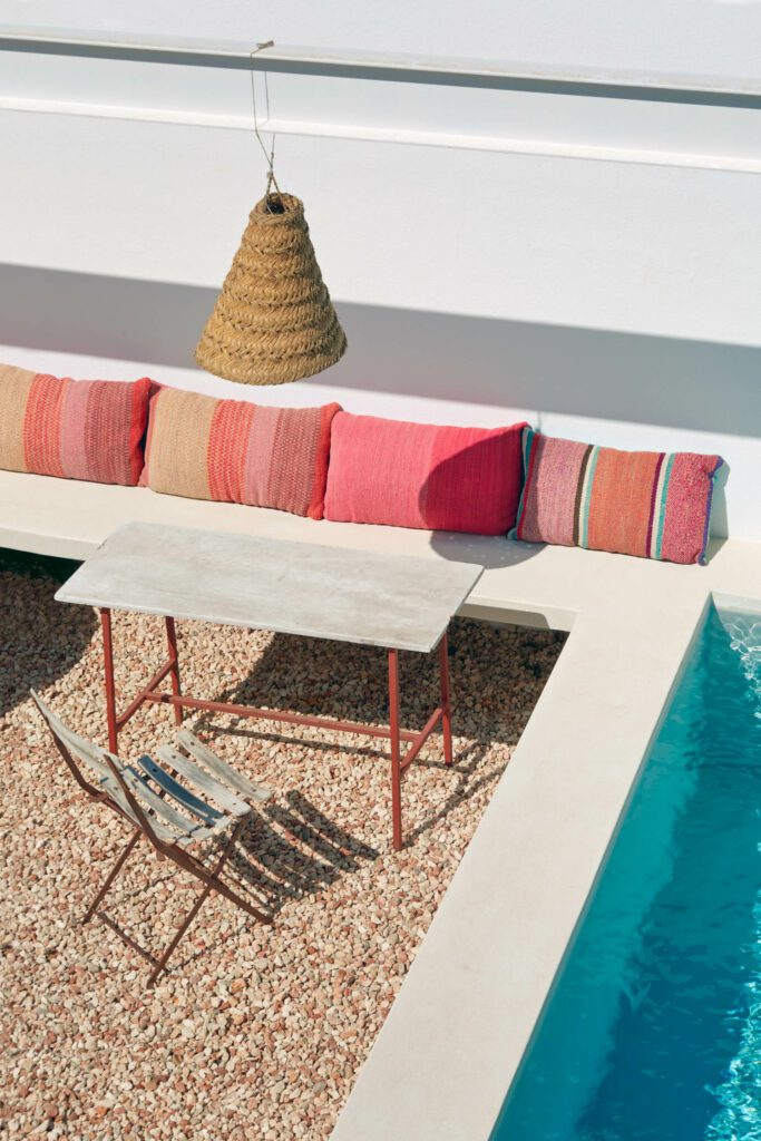 An antique patio set is poolside