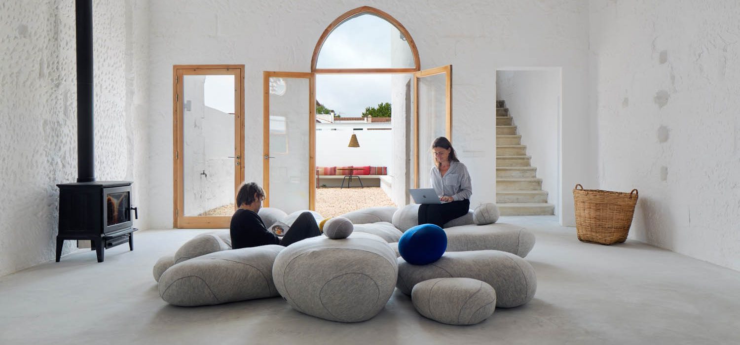 Oversized wool Livingstones poufs by French design studio Smarin surround the fireplace, like an array of pebbles on a beach.