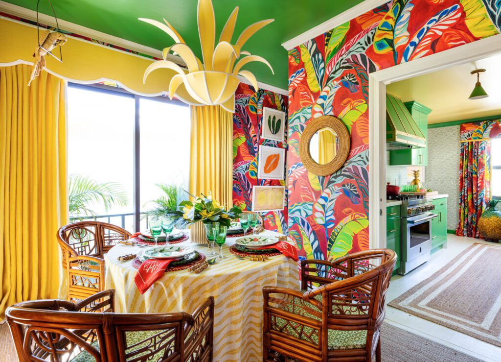 Banana leaf patterned wall paper adorns the walls of this room with table and chairs in the center