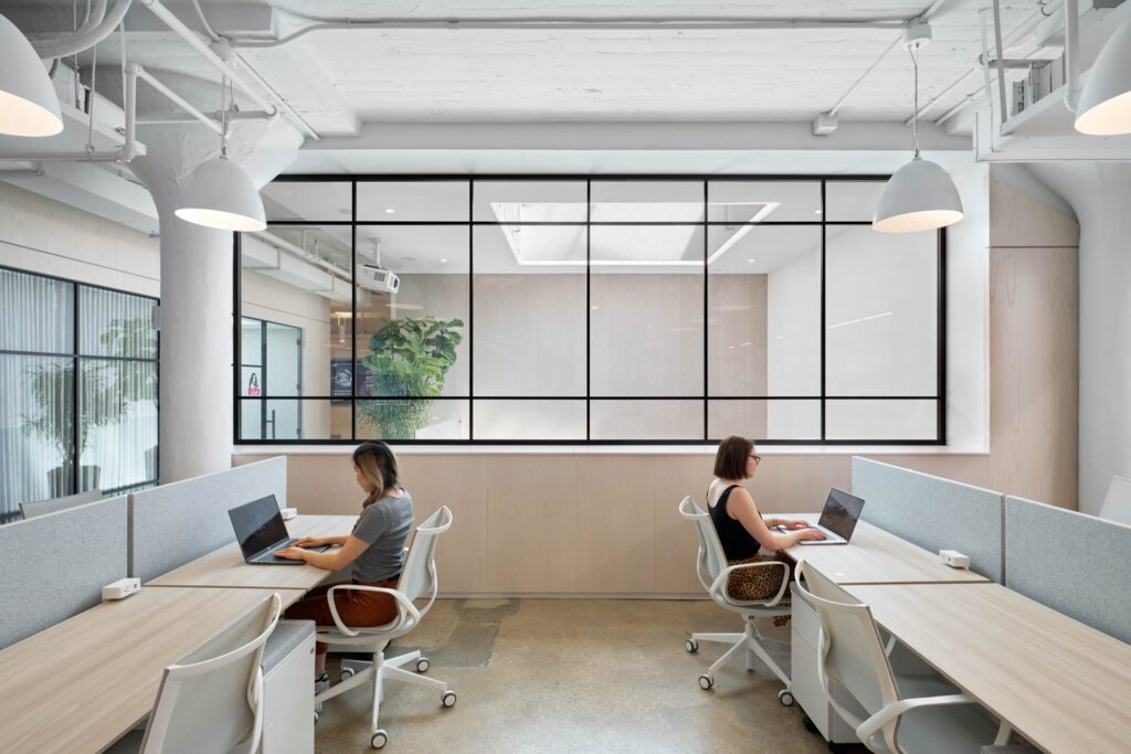 A glass partition in front of a co-working space at ROKT