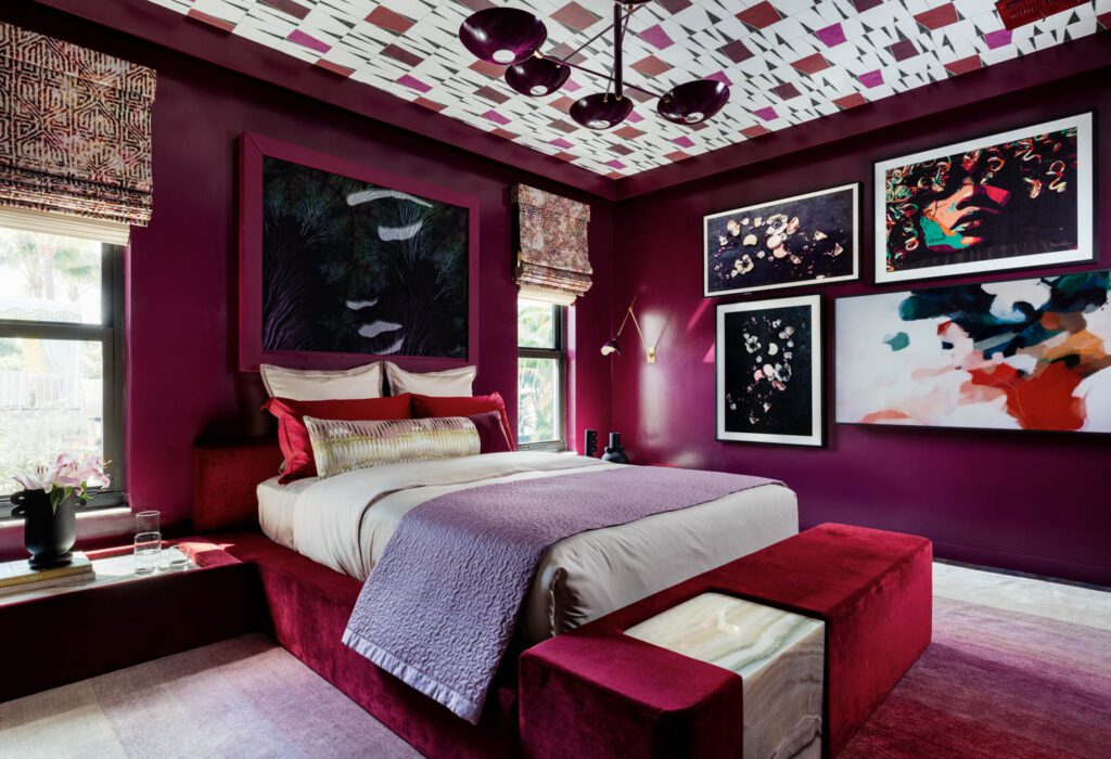 A guest suite covered in deep red velvet and artwork on the walls