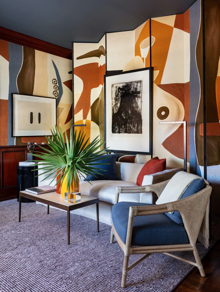 A sitting room with modern designs painted on the walls