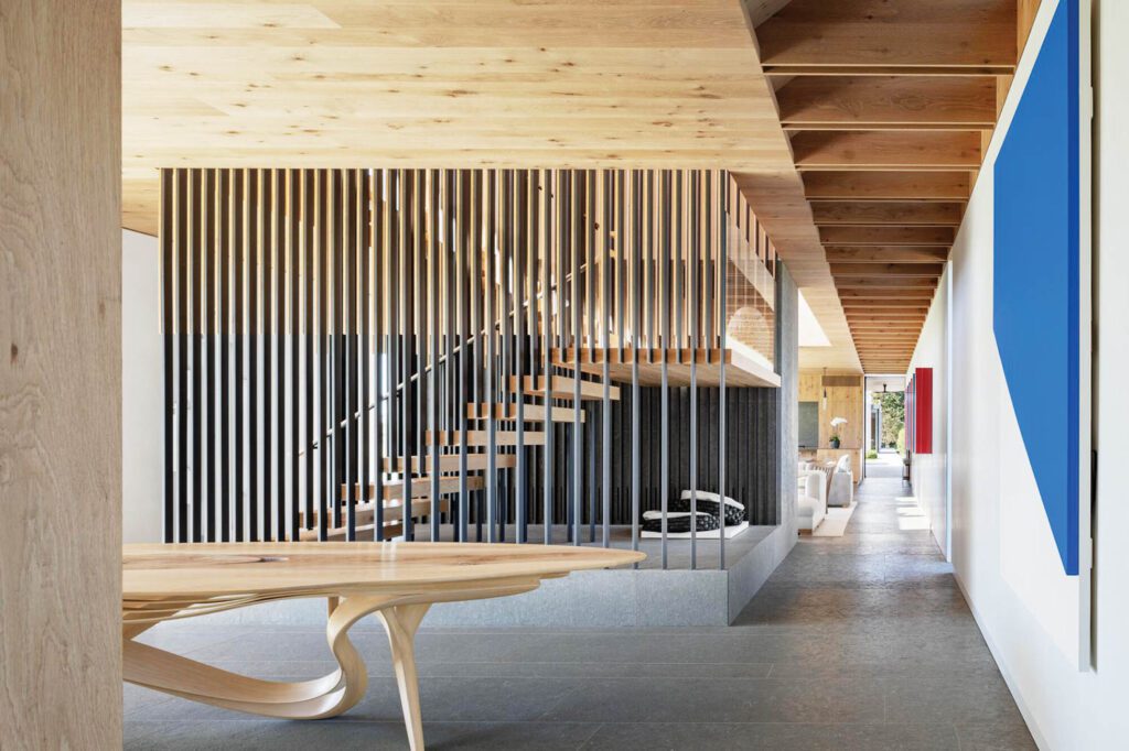 In the dining area, an Ellsworth Kelly painting faces a sculptural table by Joseph Walsh.