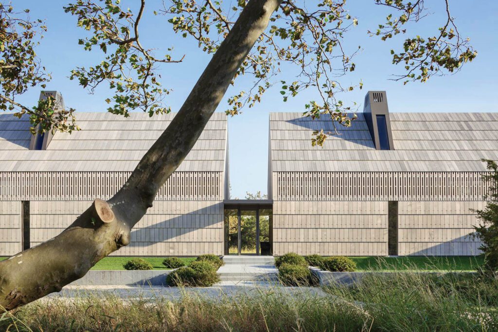 Cedar shingles clad most exterior surfaces, including the roof.