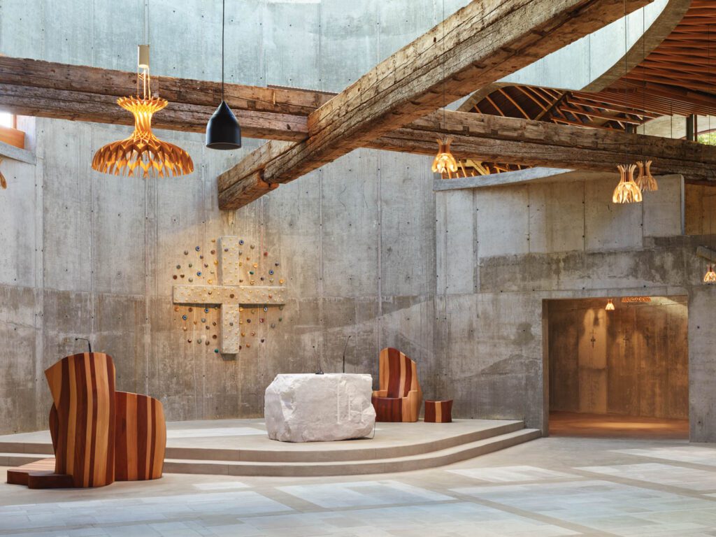 Inside, beneath 500-year-old nonstructural beams, the altar, carved from a single block of Italian limestone, is backed by a site-specific cross sculpture by Enzo Cucchi.