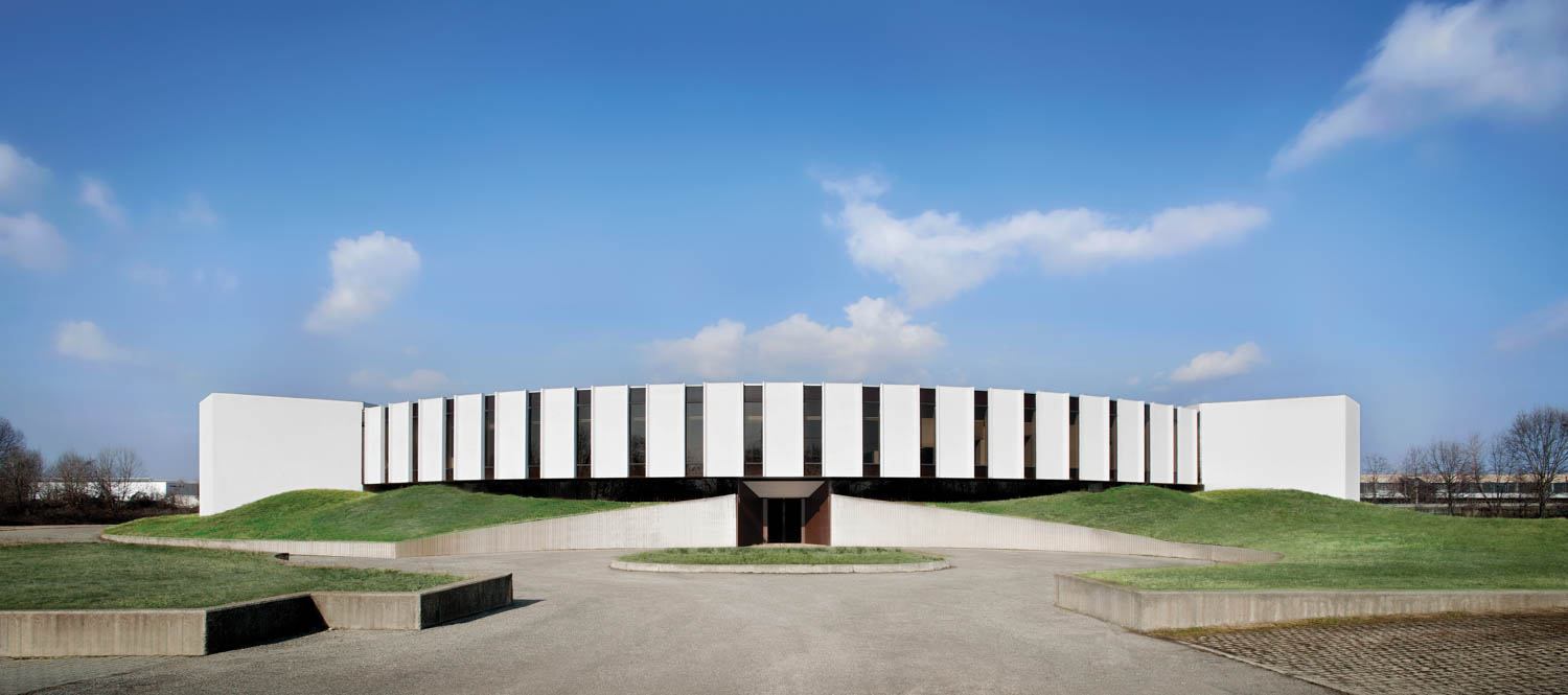 The exterior of the building features a curved, white facade. 